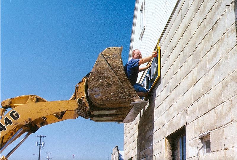 scan0040.jpg - Installing the sign on the new building