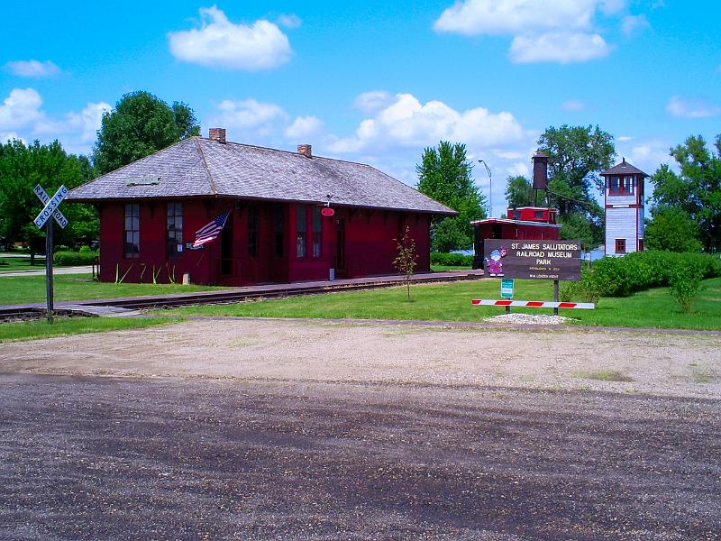 S5030010.JPG - Iems in front of the depot are a former GTW caboose, a switch tower and a sanding tower.